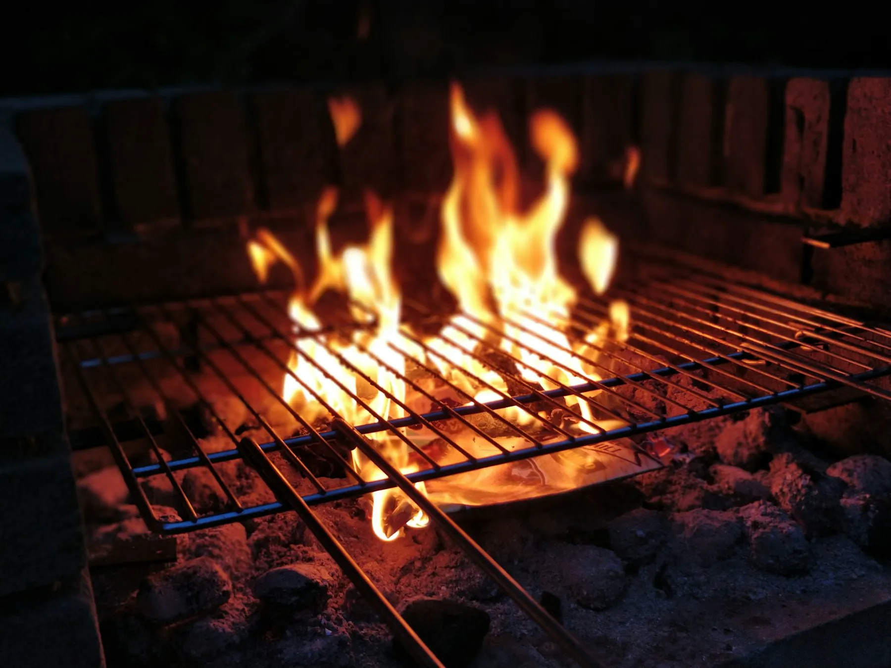 Tall birch flames rising from the SAVU grill