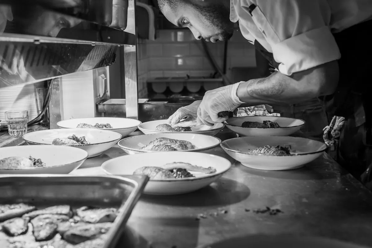Plates lined up on the pass in the SAVU kitchen